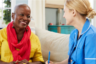 medical social worker counseling senior woman smiling