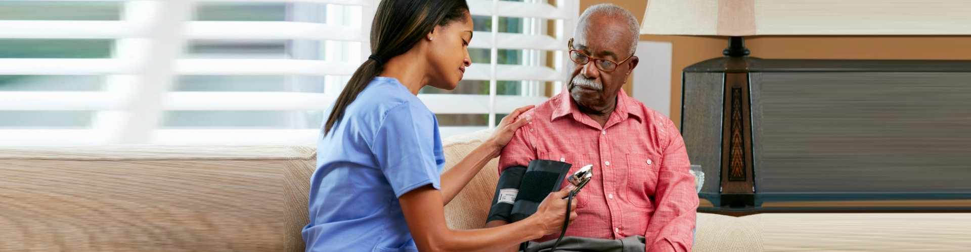 female nurse doing blood pressure monitoring to senior man