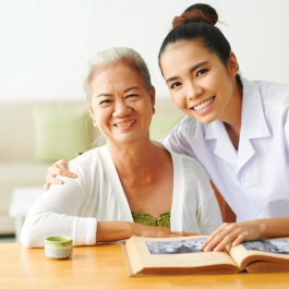 staff and elderly woman smiling
